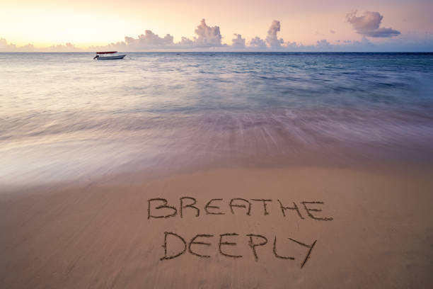 istock handwritten Breathe deeply on sandy beach 1218238173