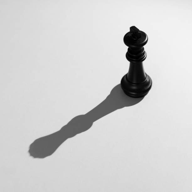 istock Black chess king with the shadow of a queen 1218238400