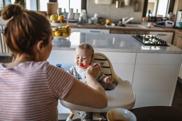 istock Mother feeds her baby son 1218238588