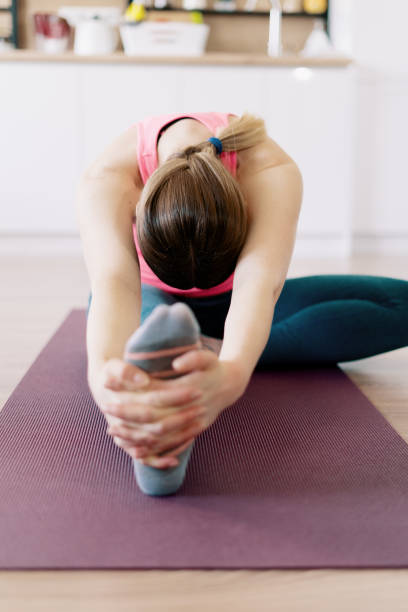 istock Caucasian woman practicing yoga at home 1218239524