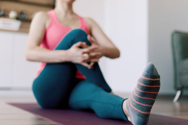 istock Caucasian woman practicing yoga at home 1218239532