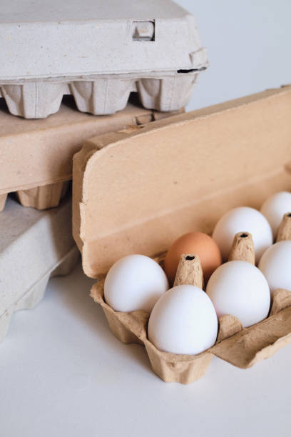 istock Cardboard boxes with chicken eggs. Boxes with uncooked eggs in table. Natural organic farm product. Preparing for Easter holiday. Fresh food delivery, carton package. Raw ingredient for cooking eat 1218241189