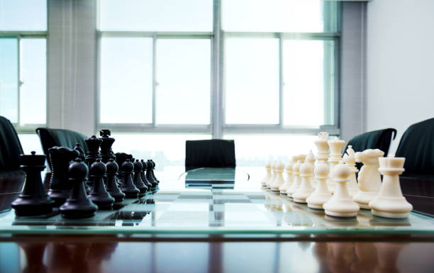 istock Chess pieces and board on the conference table 1218241563
