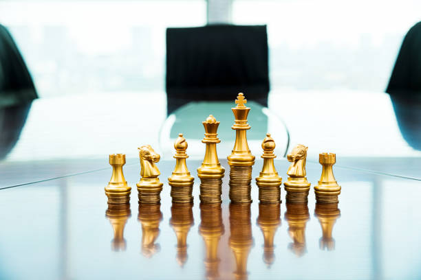 istock Chess pieces standing on the stacked coins 1218241695