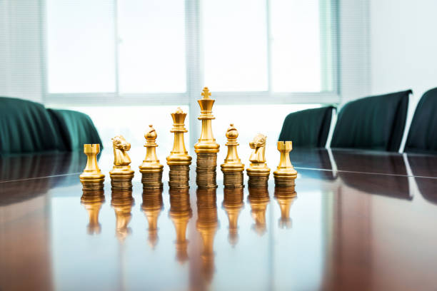 istock Chess pieces standing on the stacked coins 1218242218