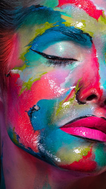 istock Face art and body art. Creative makeup with colorful patterns on the face. Modern makeup art, bold style, 1218243722
