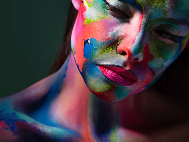 istock Face art and body art. Creative makeup with colorful patterns on the face. Modern makeup art, bold style, 1218243736