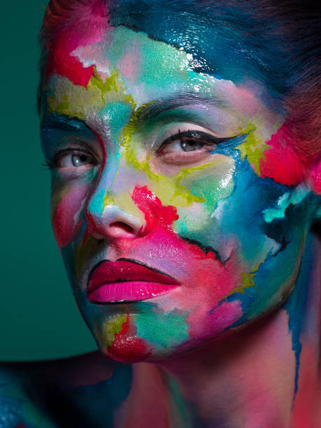 istock Face art and body art. Creative makeup with colorful patterns on the face. Modern makeup art, bold style, 1218243786