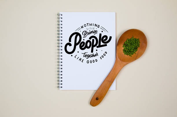 istock Wooden ladle with some herb spice and a blank notebook page 1218245784