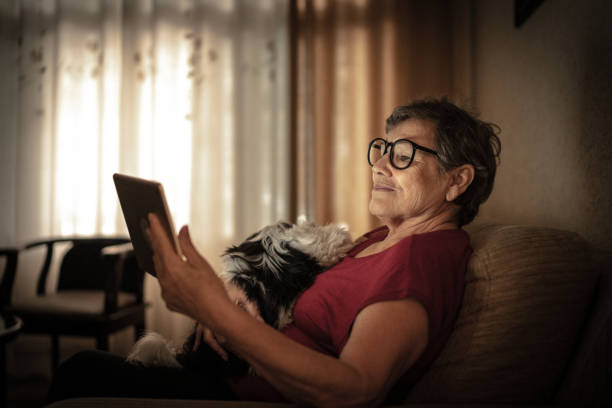 istock Senior woman doing a video call using a digital tablet at home 1218247074