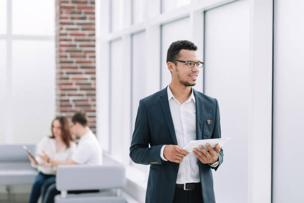 istock modern businessman with digital tablet standing in office 1218247128