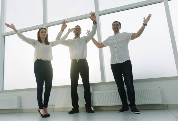 istock young business team standing in a bright office 1218249154