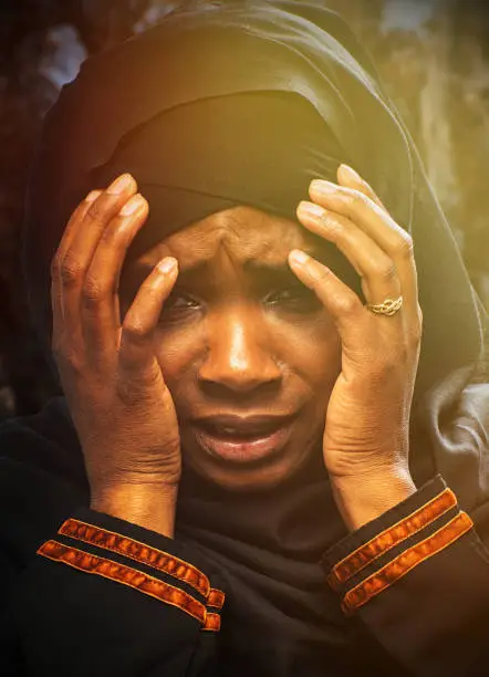 Terrified black refugee muslim young woman because the horrors of pandemic