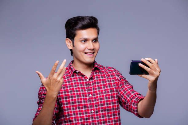 istock Handsome Indian man using mobile phone - stock photo 1218250981
