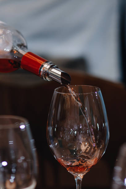 istock Red wine pouring into wine glass, close-up 1218251044