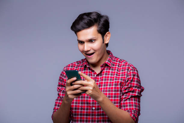 istock Handsome Indian man using mobile phone - stock photo 1218251562