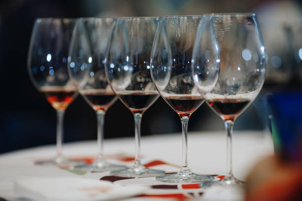 istock Red wine pouring into wine glass, close-up 1218251768