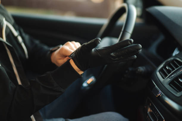 istock Man in car put on black gloves to protect himself 1218253804