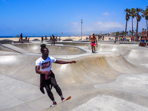 Skaters are training at the skatepark of Venice beach in July 2019 in Los Angeles