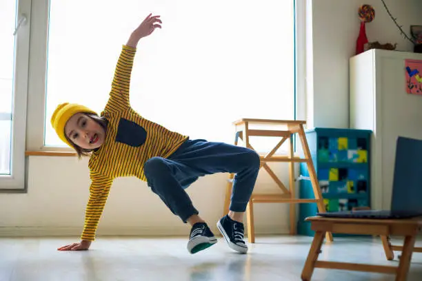 Photo of Little boy dancing break at home. Home Pleasures.