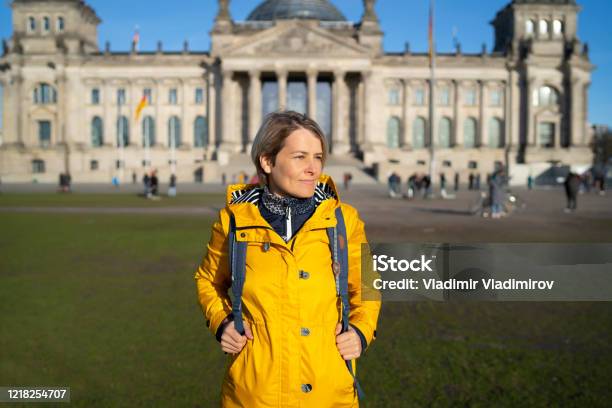 Tourist Woman In Berlin Stock Photo - Download Image Now - Backpack, Berlin, Yellow