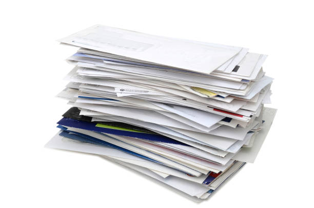 istock Stacking of letter mails on white 1218254731