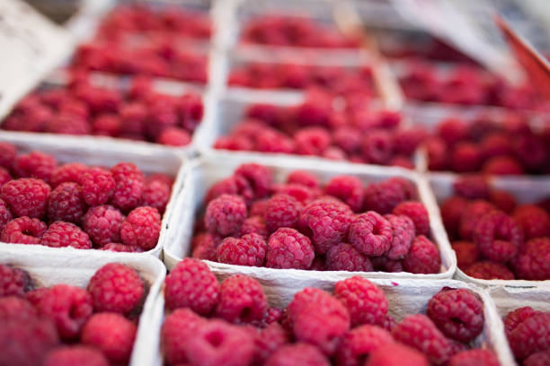 Fresh raspberries box sold in a market stall