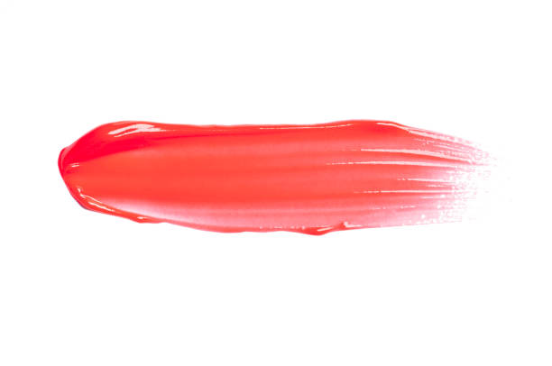 istock Pink purple dark red shimmering lip gloss on white background 1218255756