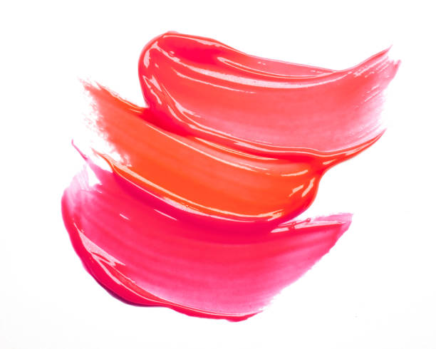 istock Pink purple dark red shimmering lip gloss on white background 1218255819
