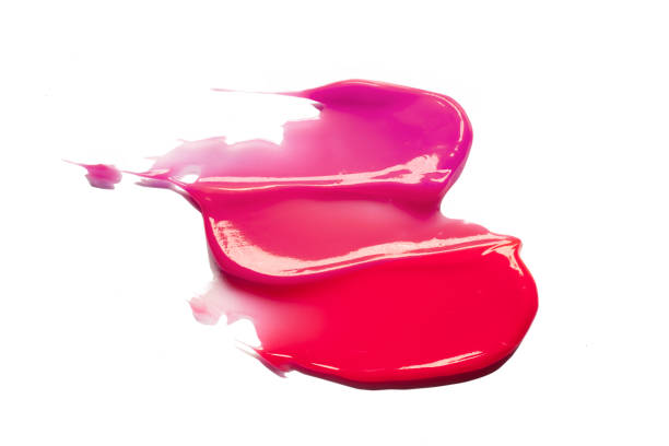 istock Pink purple dark red shimmering lip gloss on white background 1218255853