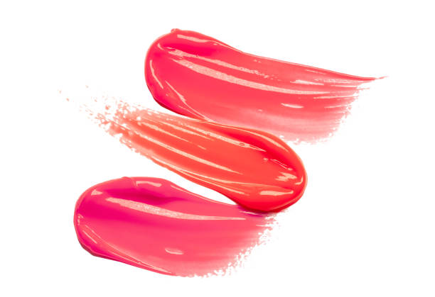 istock Pink purple dark red shimmering lip gloss on white background 1218255944