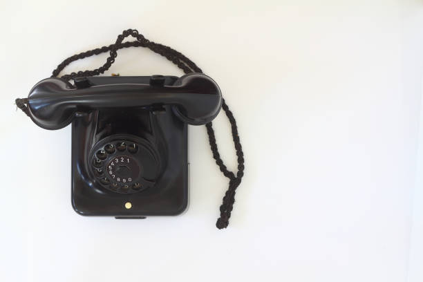 istock black old telephone receiver hanging on white background with texting space, waiting for phone call, vintage telephone 1218258071