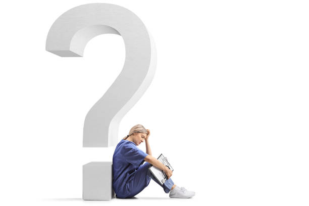 Tired female doctor sitting on the ground and leaning on a big question mark Tired female doctor sitting on the ground and leaning on a big question mark isolated on white background question mark depression sitting asking stock pictures, royalty-free photos & images
