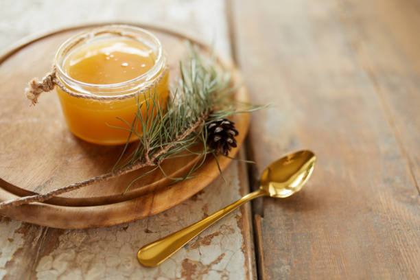 Honey jar on vintage wooden table. Top side view with copy space. Selective focus stock photo