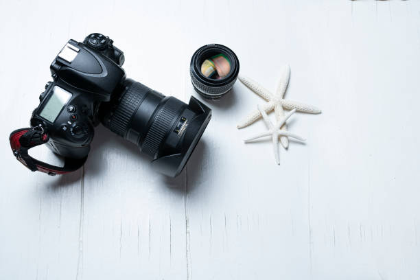 istock Photographic equipment on beach theme background 1218259137