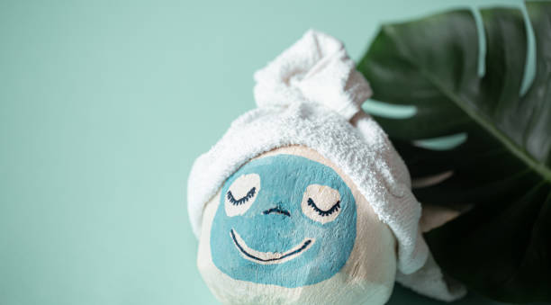 istock Creative Spa concept .Coconut with a face mask . 1218259186