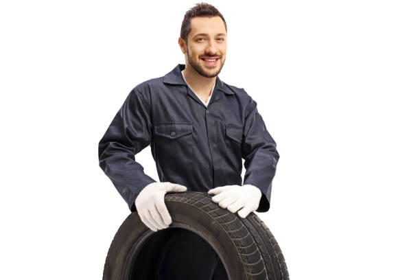 istock Auto mechanic holding a car tire 1218259390