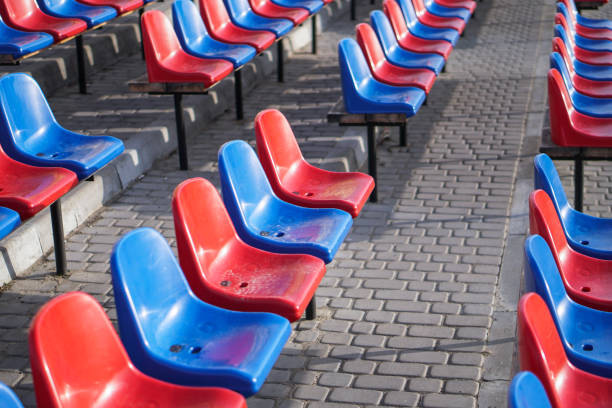 istock Multi-colored seats in the rain. Dirty stools on the street. 1218259596