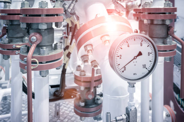 industrial  concept. equipment of the boiler-house, - valves, tubes, pressure gauges, thermometer. close up of manometer, pipe, flow meter, water pumps and valves of heating system in a boiler room. - boiler power station fuel and power generation gas boiler imagens e fotografias de stock