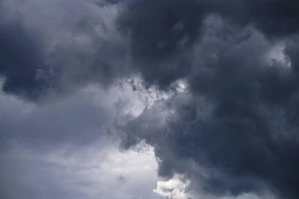 istock Terrible thunderclouds from the side of a plane. Gloomy epic clouds. Background image in a dark gray style. 1218262051
