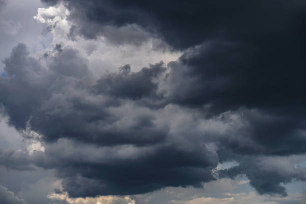 istock Terrible thunderclouds from the side of a plane. Gloomy epic clouds. Background image in a dark gray style. 1218262177