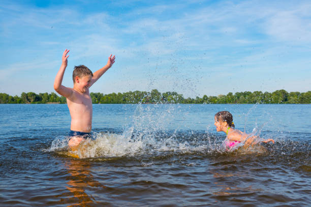 istock Children in the river are splashed with water.  A hot sunny summer day. 1218263838