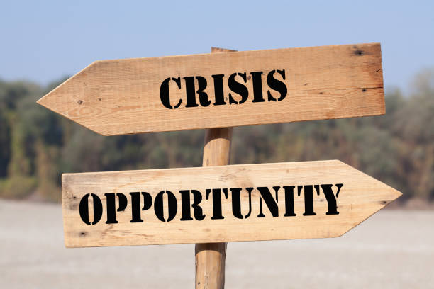 Crisis Opportunity Choice Crisis or opportunity words on wooden road sign with left and right arrows. bad investment strategy stock pictures, royalty-free photos & images
