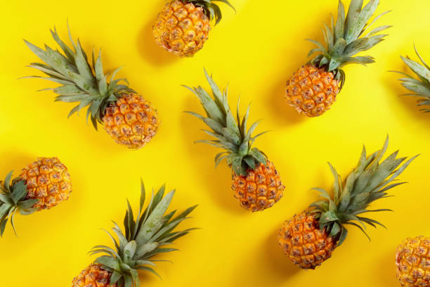 istock Ripe pineapples on a yellow background. 1218264903