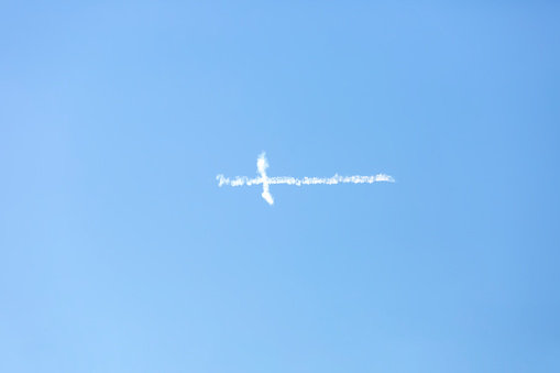 Cross in the blue sky, background with copy space, full frame horizontal composition