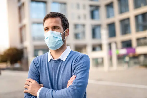 Portrait of a man with a protection mask looking away. Virus epidemic.