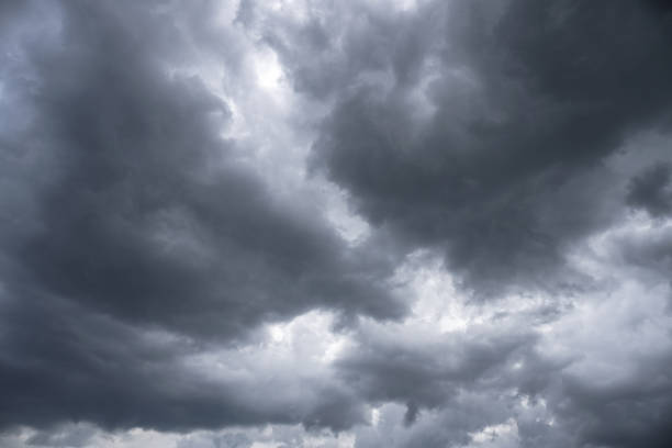 istock Terrible thunderclouds from the side of a plane. Gloomy epic clouds. Background image in a dark gray style. 1218267045