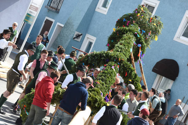 Maypole installation in St. Georgen (Vöcklabruck district, Upper Austria, Austria) - A maypole is a decorated tree or trunk that will be placed in Austria on May 1 (usually April 30) in the village or town square.