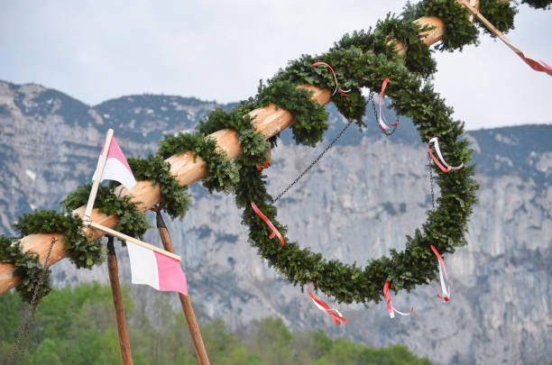 Maypole installation in Steinbach am Attersee (Vöcklabruck district, Upper Austria, Austria) - A maypole is a decorated tree or trunk that will be placed in Austria on May 1 (usually April 30) in the village or town square.