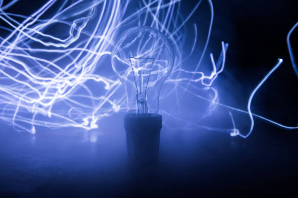 istock Abstract dark background with creative artwork decoration of glowing bulbs. 1218268493